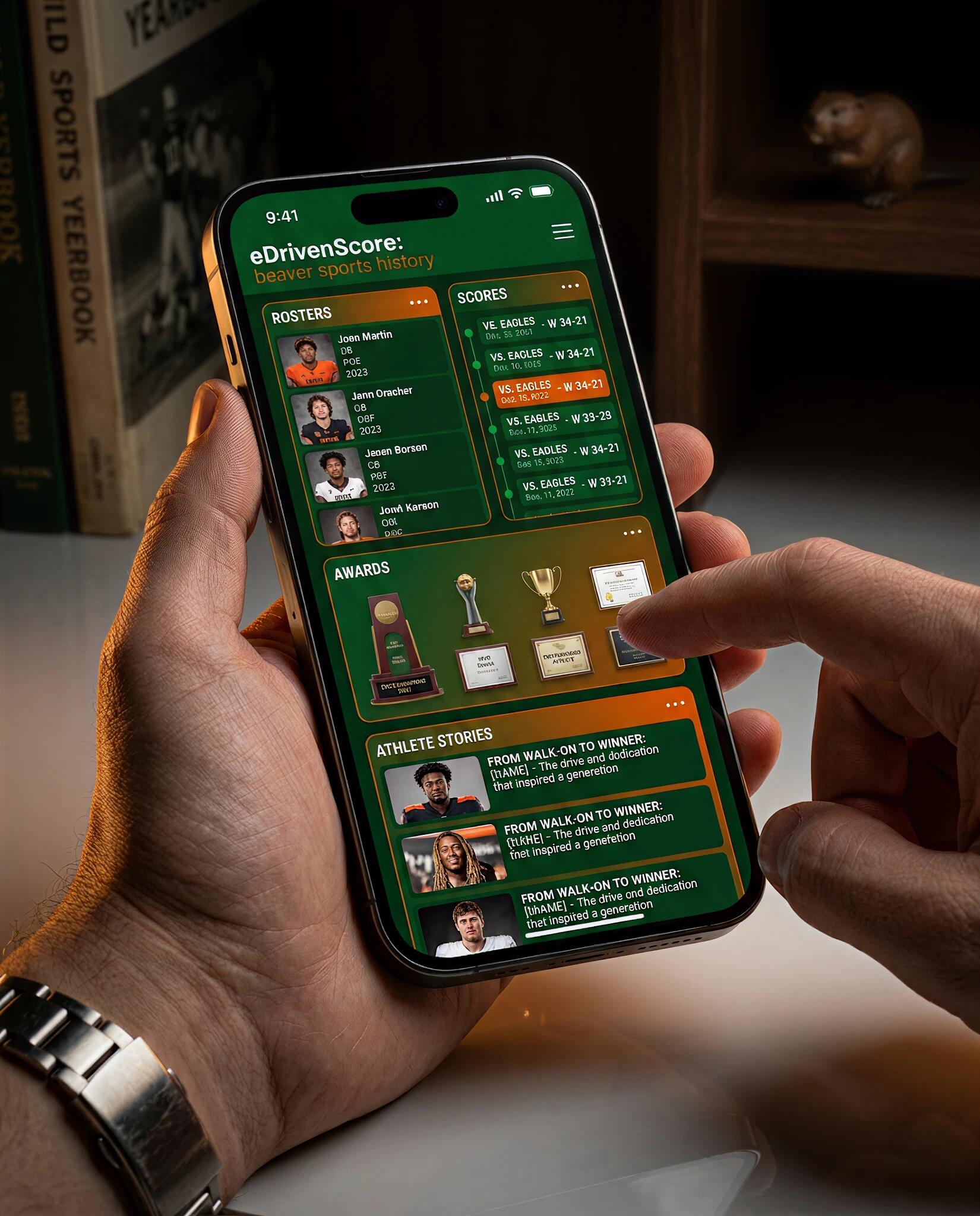 Hand holding a phone showing the eDriven SCORE rosters and scores app